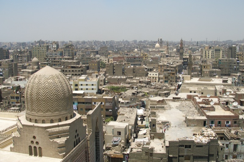 Cairo city skyline view with the Nile in the foreground and the citadel visible on the horizon